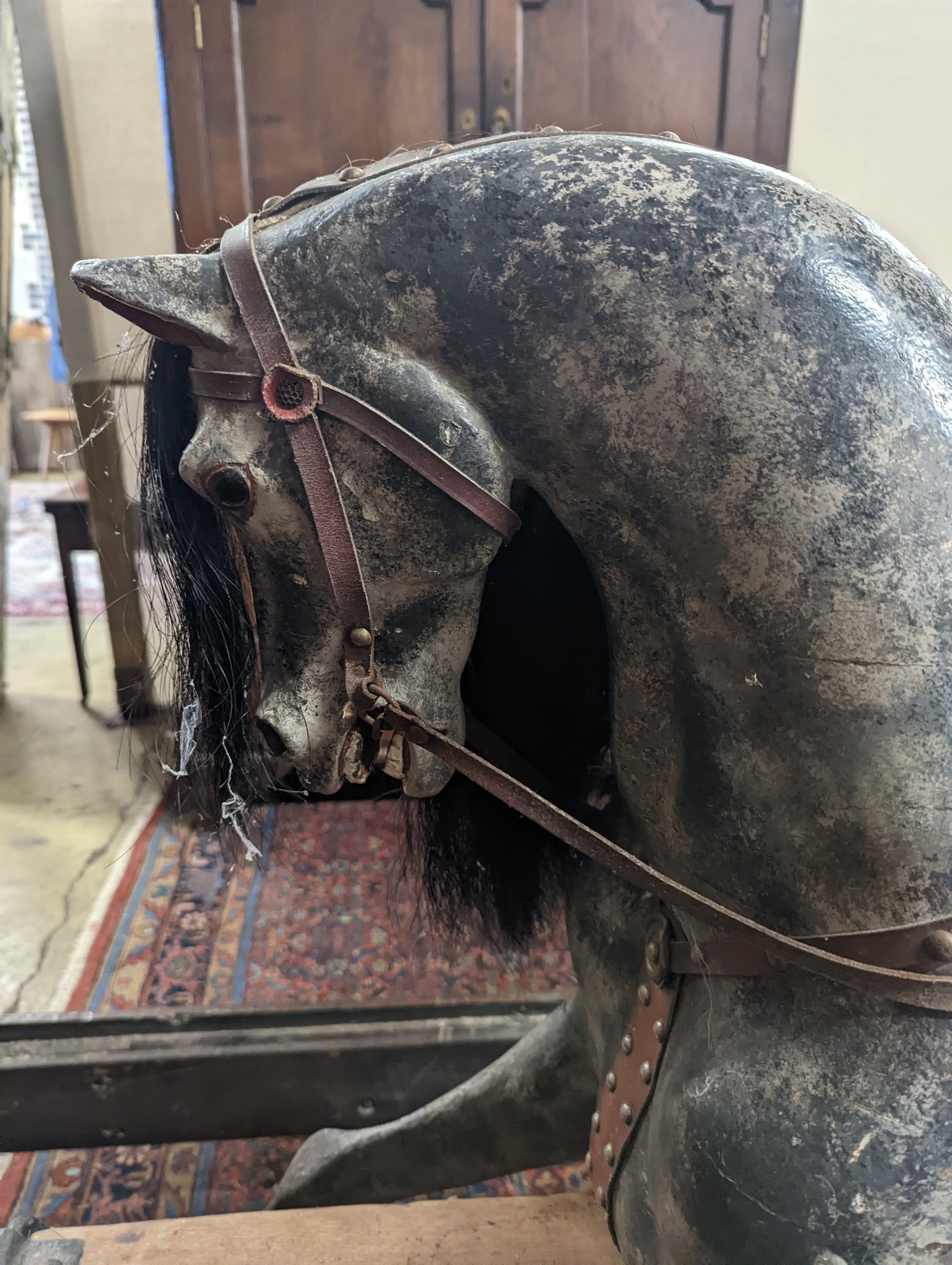 A large Edwardian Ayres type rocking horse on a turned safety frame, length 160cm, height 110cm